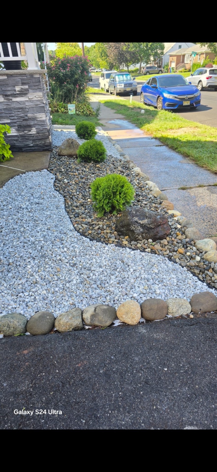 River rock landscaping installation